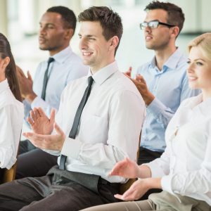 Group of people clapping hands during a meeting conference.